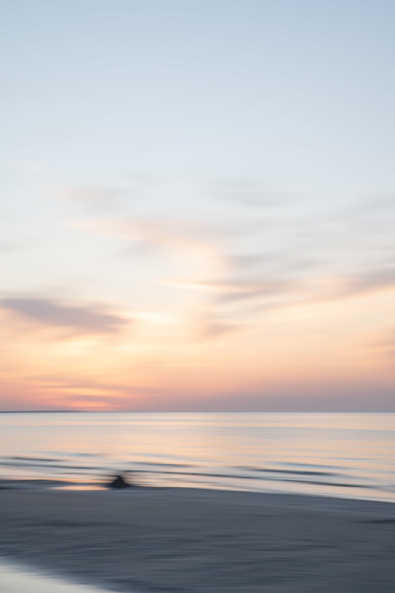 A tranquil seascape where the horizon gently blends the sky and sea, softened like hand-blended paint.